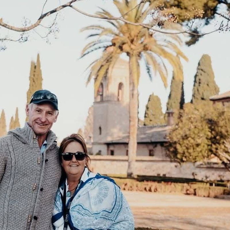 Ana Sterrenberg, design and finish lead at SilverCoast Paws & Home, photographed with Michael at the gardens of the Alhambra in Granada