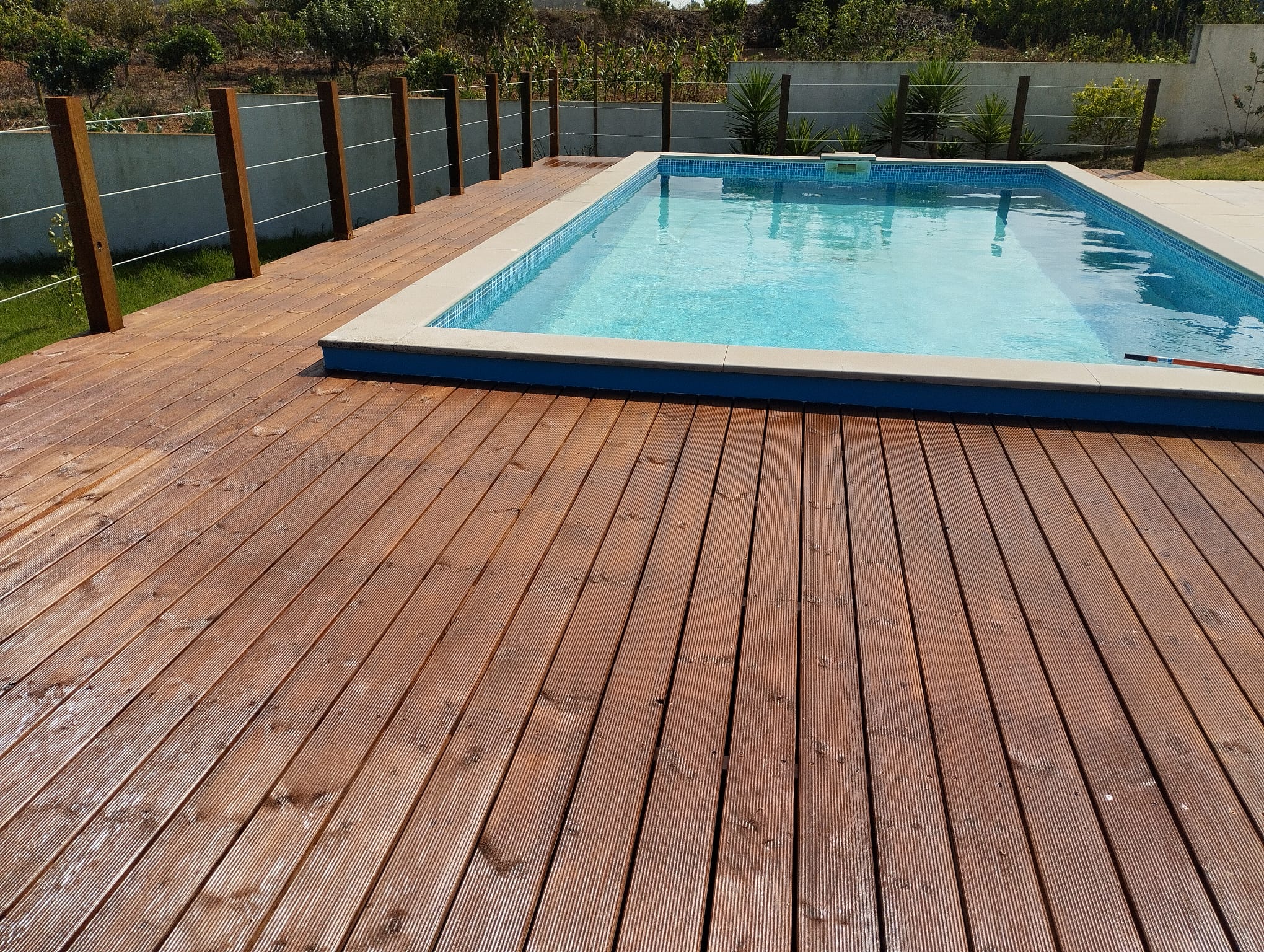 A second finished hardwood pool deck by Michael Sterrenberg with aluminium perimeter railing, fresh timber and a clear blue pool on the Silver Coast
